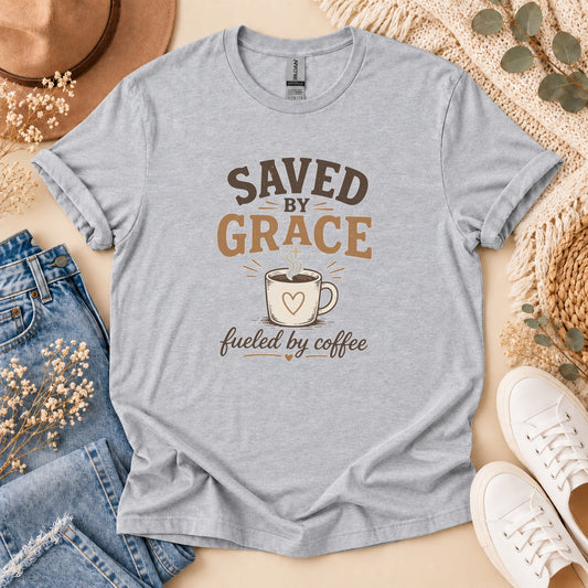 Light grey t-shirt with "Saved By Grace Fueled By Coffee" text and coffee cup graphic.