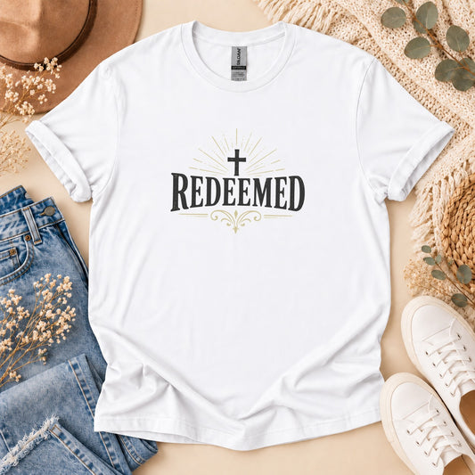 White t-shirt with "Redeemed" and a cross graphic.