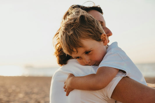 A bonus mom hugging her stepson warmly outdoors — Christian Gifts for Bonus Kids from Nordenzi