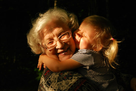 An elderly grandmother warmly hugging her young grandchild — Nordenzi's look at grandparent generosity and whether spoiling grandkids is really a bad thing