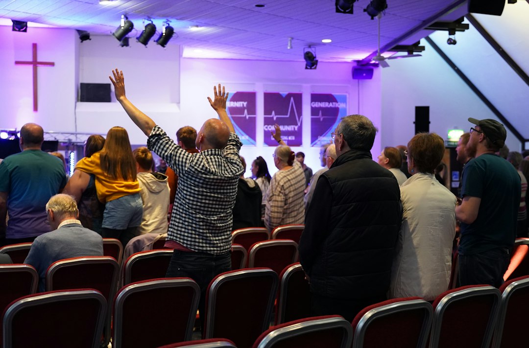 Congregation worshipping together with hands raised in church — Pastor Appreciation from Nordenzi