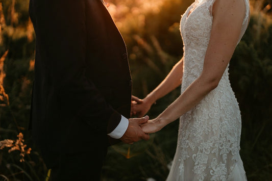 Bride and groom holding hands as the sun sets on their wedding day — Wedding Card Messages from Nordenzi