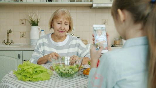 Grandmother and granddaughter cooking together in the kitchen — Christian Gifts for Grandma from Nordenzi