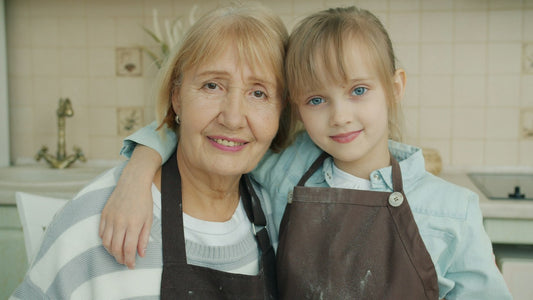 Grandmother and granddaughter smiling together in the kitchen — Christian Christmas gifts for grandparents from Nordenzi
