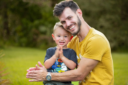 A father and son laughing together outdoors, a warm picture of the bond a Christian gift for Dad from Nordenzi is meant to honor