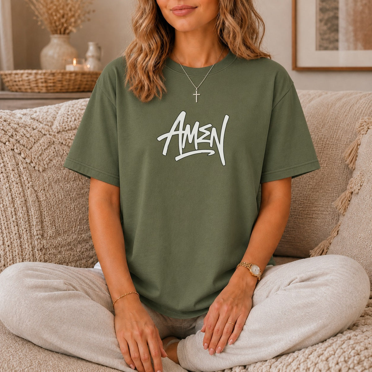Olive green t-shirt with white "AMEN" graphic and silver cross necklace.