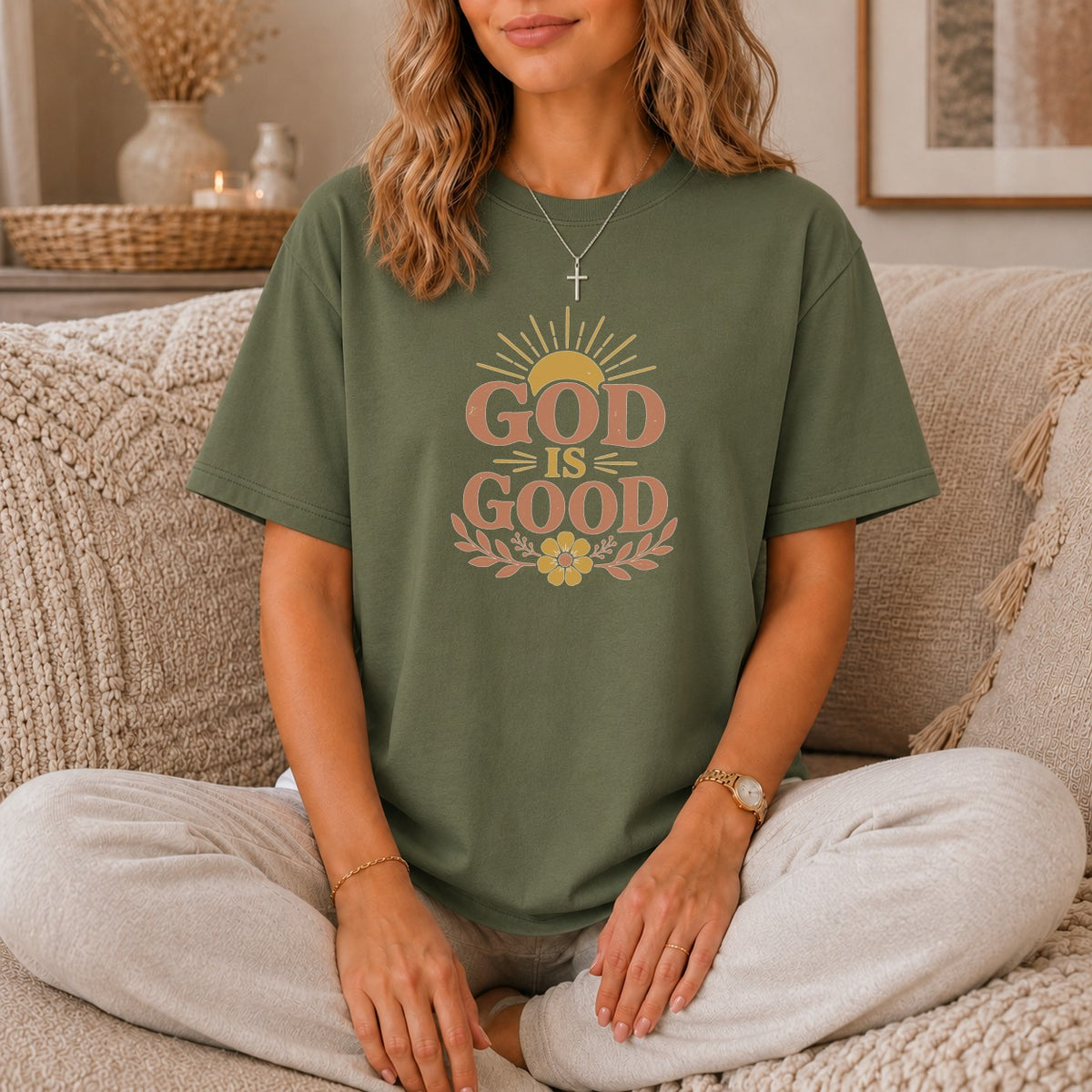 Olive green t-shirt with "GOD IS GOOD" text and sun graphic.