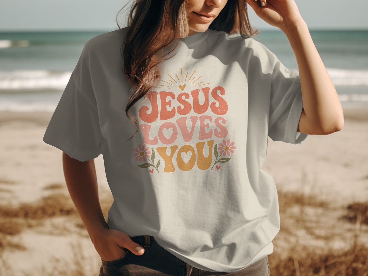 Light gray t-shirt with "Jesus Loves You" graphic and floral accents
