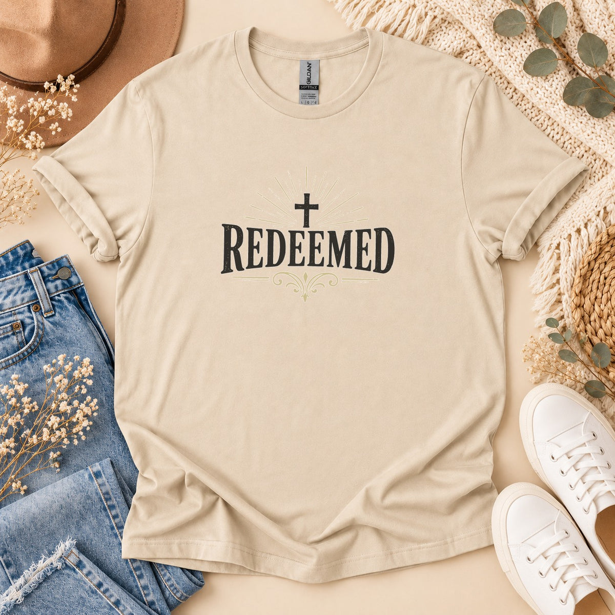 Tan t-shirt with "Redeemed" and a cross graphic.