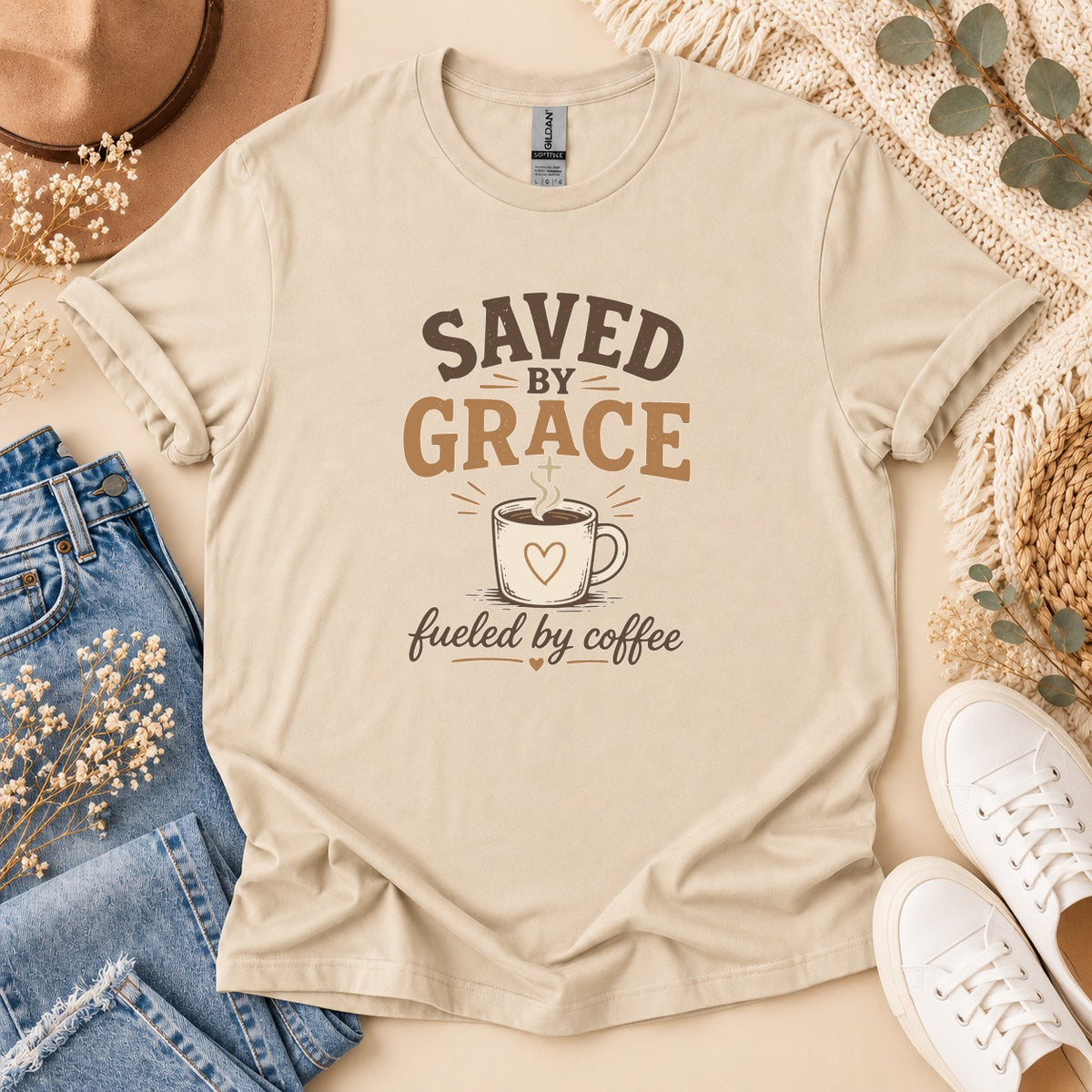Light tan t-shirt with "Saved by Grace Fueled by Coffee" graphic and coffee cup.