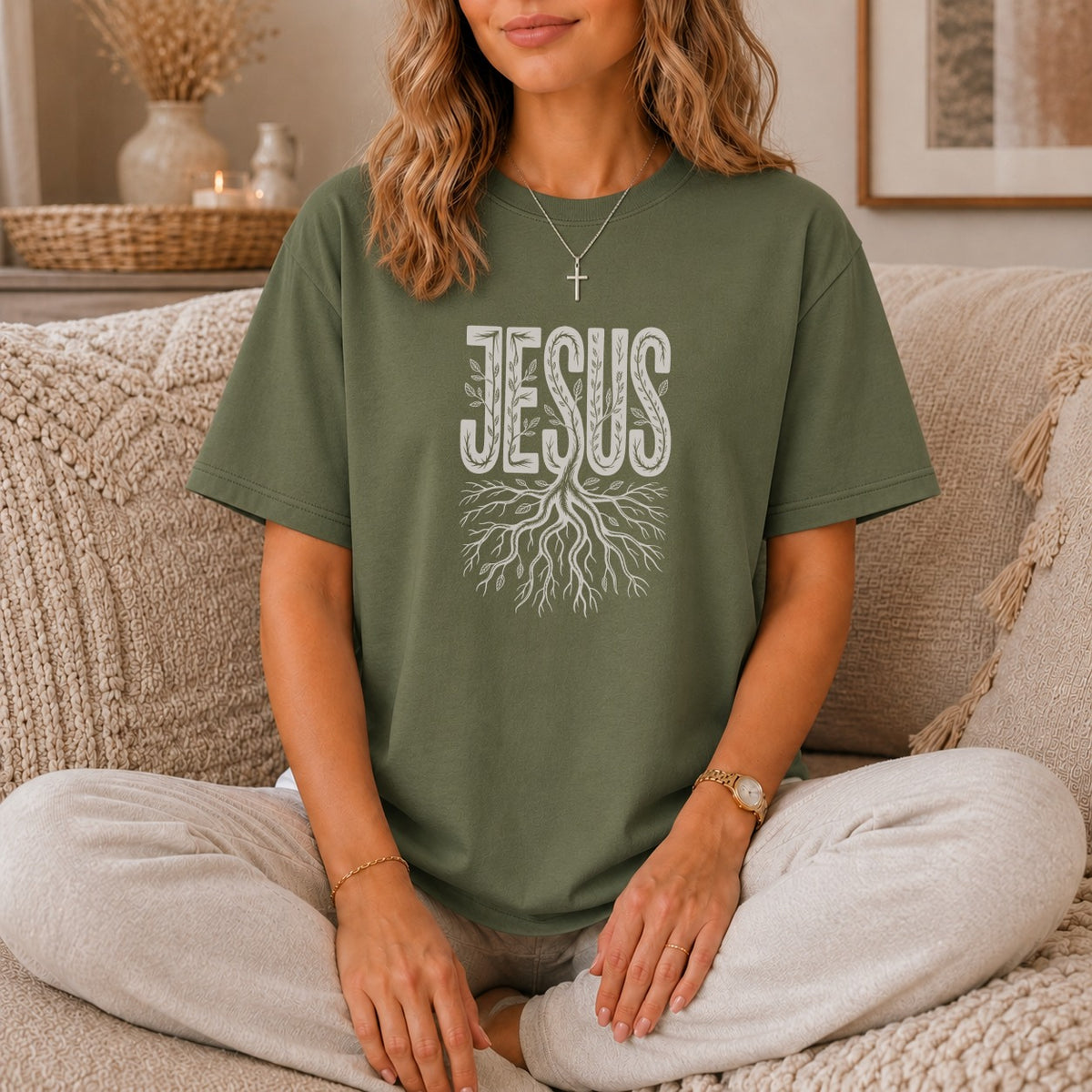Olive green t-shirt with white "JESUS" text and tree roots graphic.