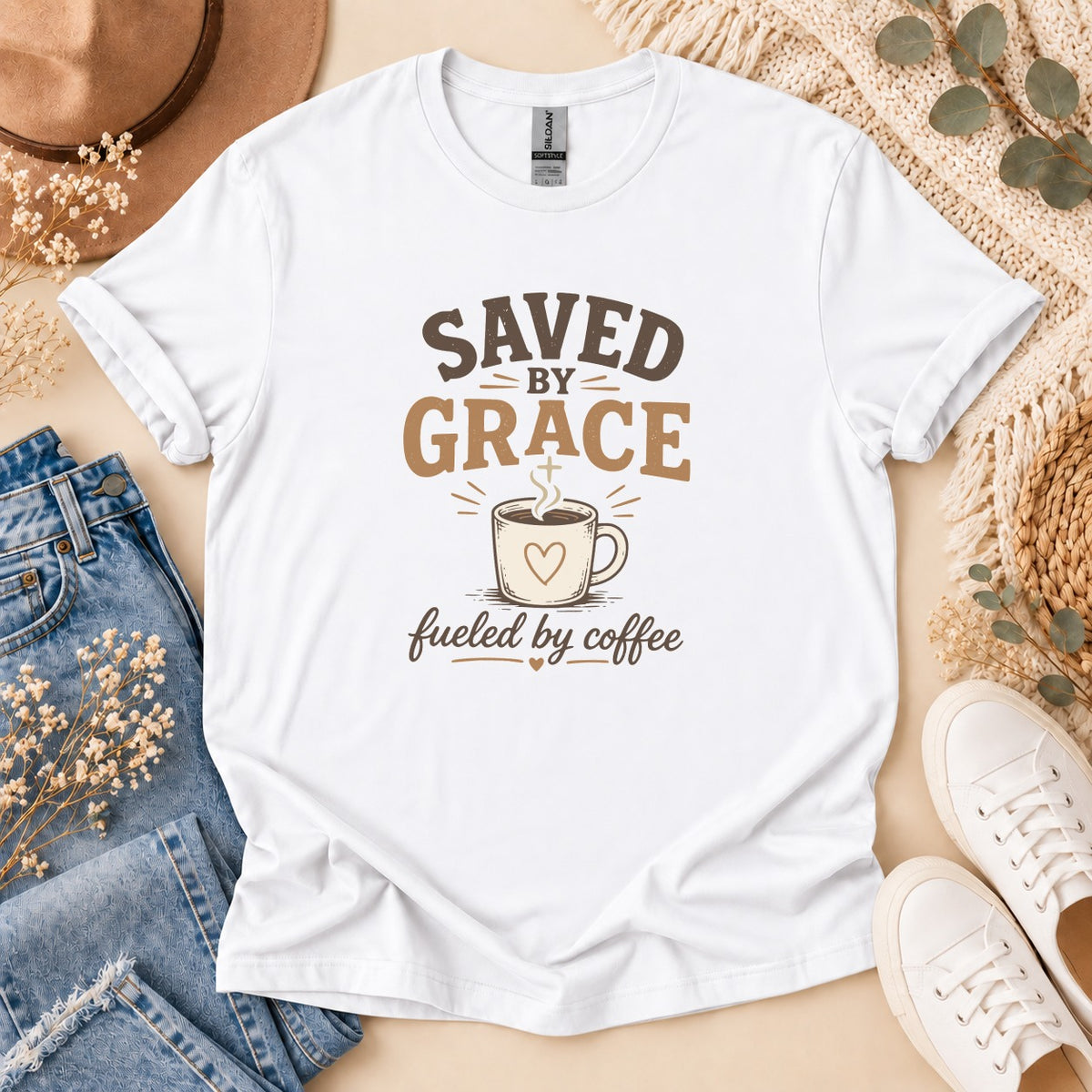 White t-shirt with "Saved by Grace Fueled by Coffee" text and coffee cup graphic.