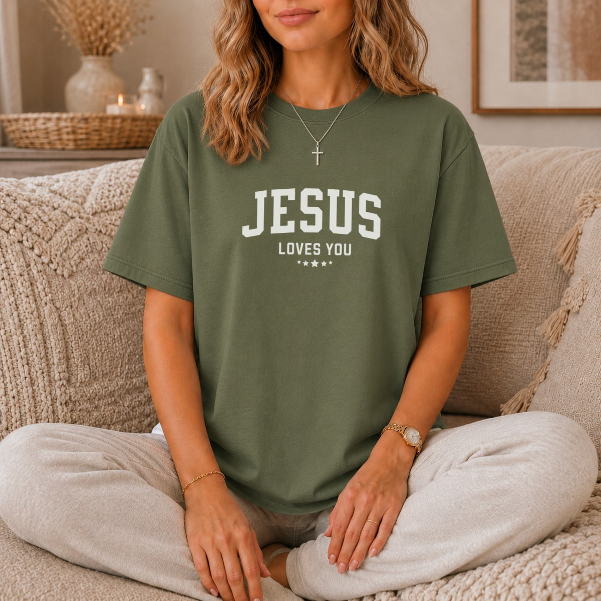 Green t-shirt with "Jesus Loves You" and three stars printed in white.