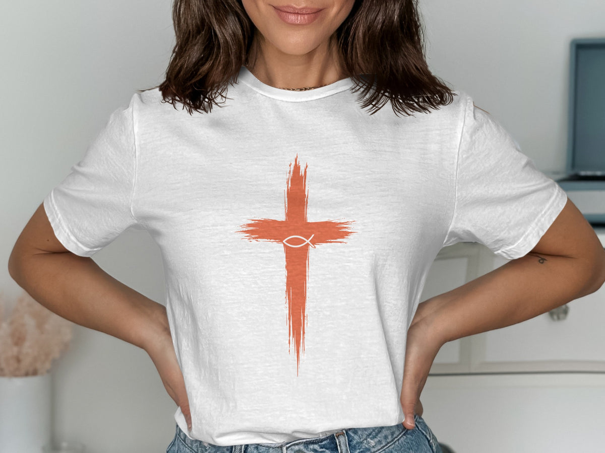 White t-shirt with orange cross and fish symbol graphic on chest