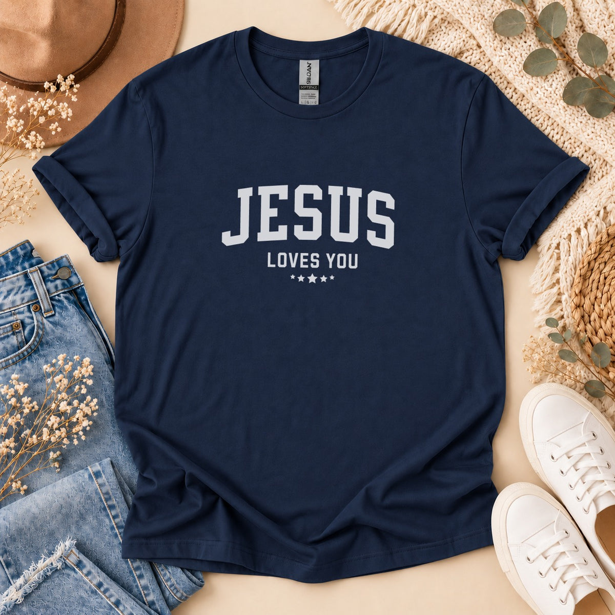 Navy t-shirt with "JESUS LOVES YOU" and stars graphic in white.
