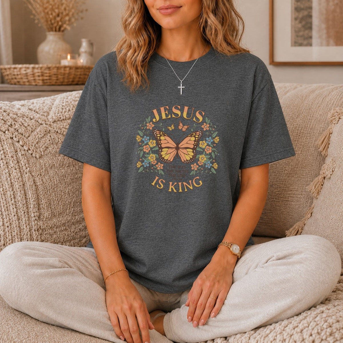 Dark gray t-shirt with "Jesus is King" text and butterfly graphic.