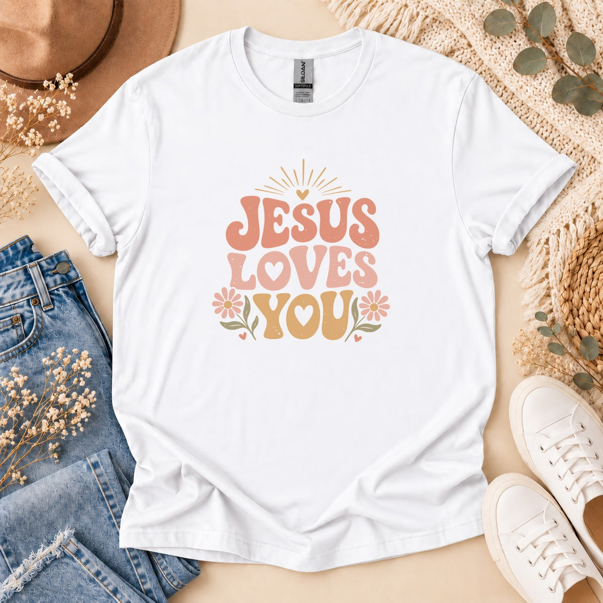 White t-shirt with "Jesus Loves You" text and floral graphics.