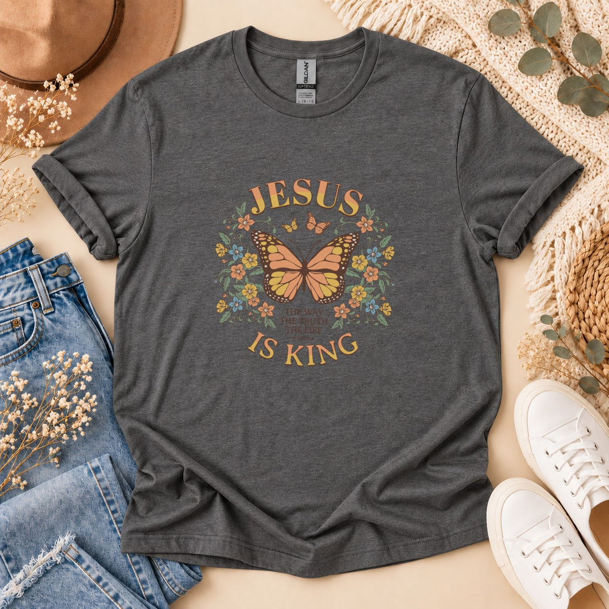 Dark gray t-shirt with "Jesus Is King" text, butterfly, and floral graphics.