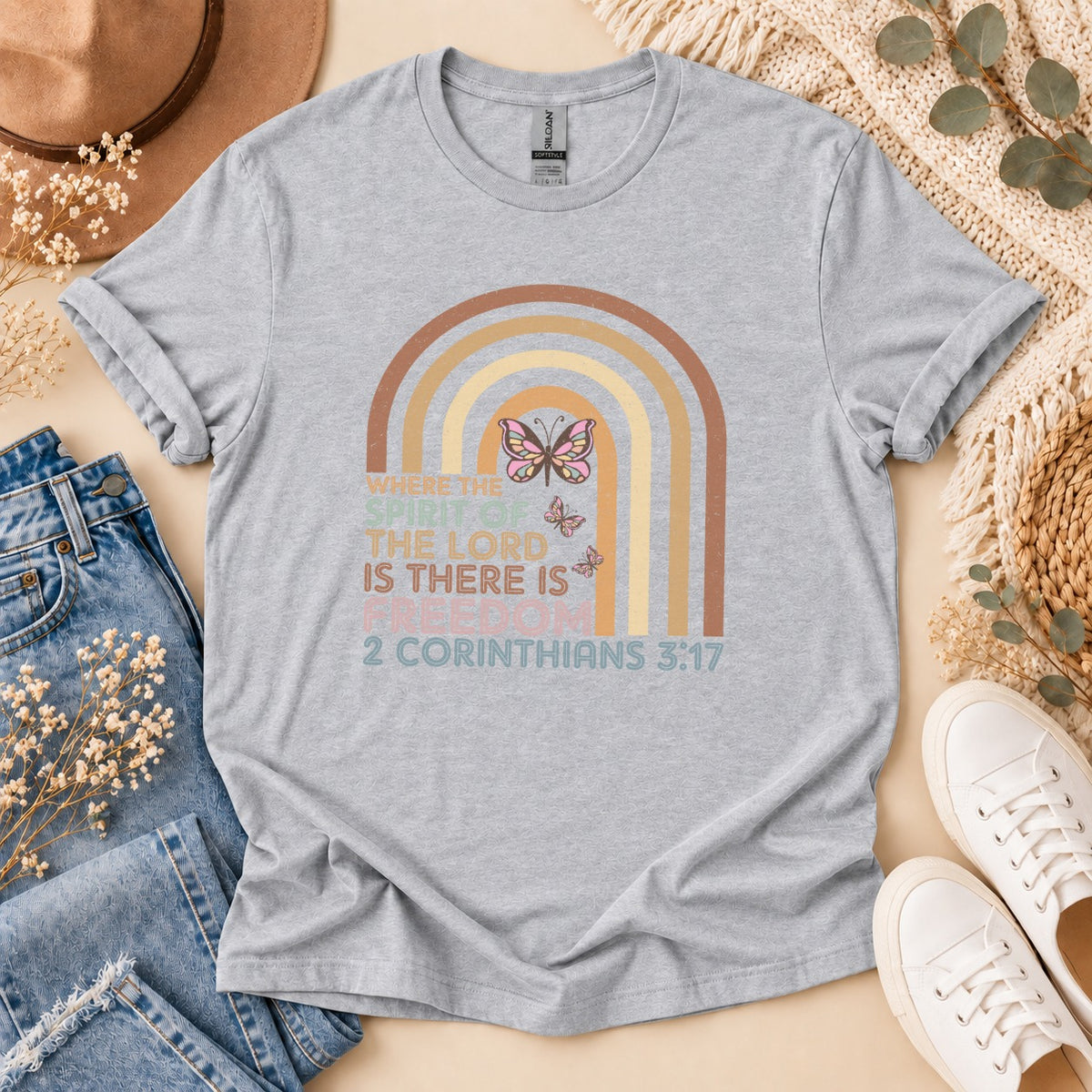 Grey t-shirt with rainbow, butterflies, and "Where the spirit of the lord is there is freedom 2 Corinthians 3:17."
