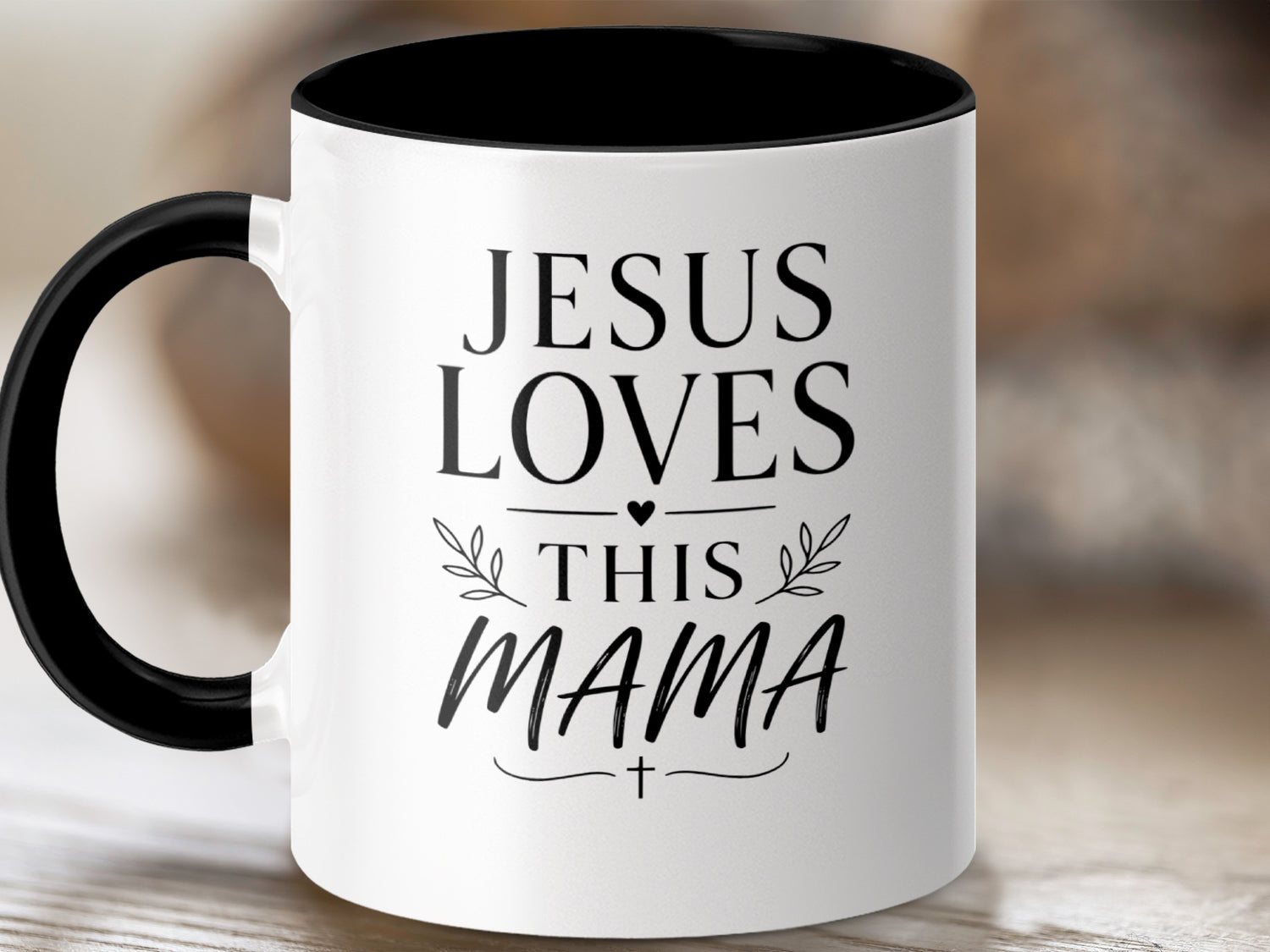 White mug with black rim and handle, text "Jesus Loves This Mama".