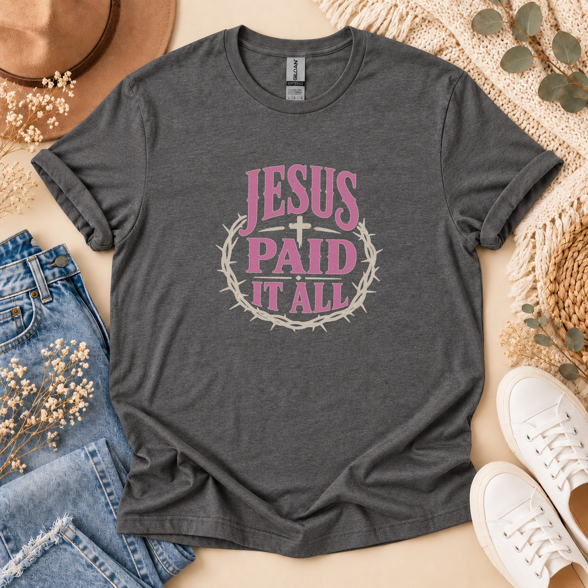 Dark grey t-shirt with pink text "Jesus Paid It All" and crown of thorns graphic.