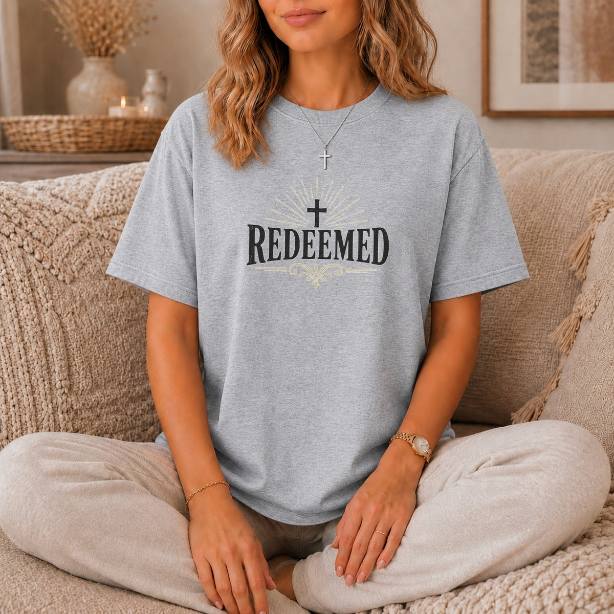 Grey t-shirt with "REDEEMED" and a cross graphic.