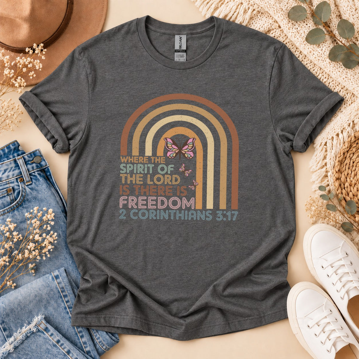 Dark gray t-shirt with rainbow and butterfly graphic. 2 Corinthians 3:17.