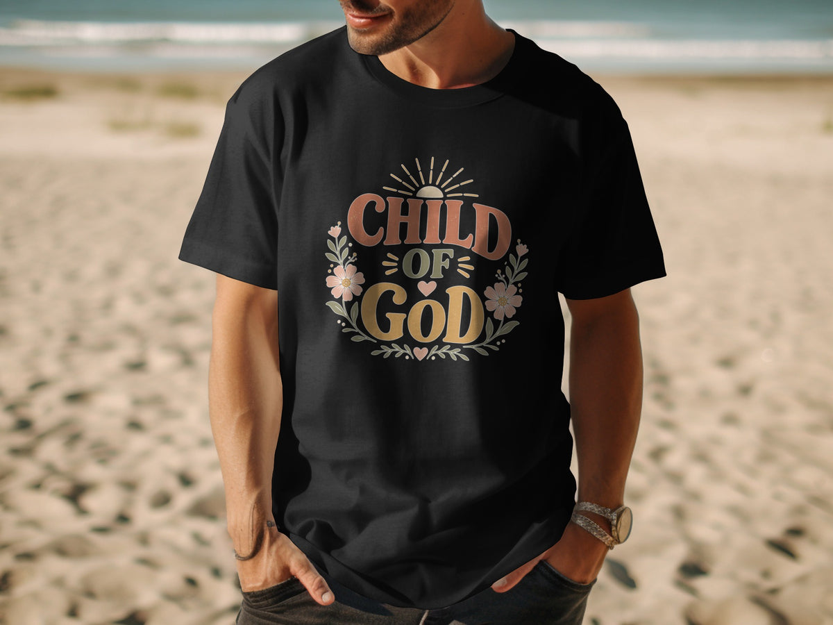 Black t-shirt with "CHILD OF GOD" text and floral design on a beach.