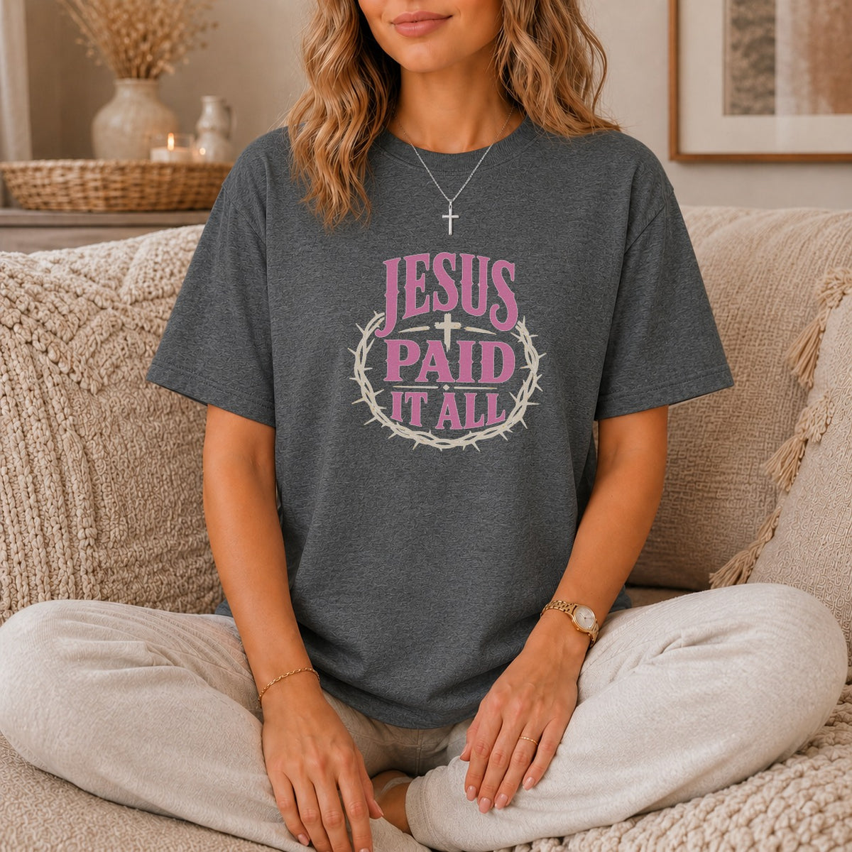 Dark gray t-shirt with pink text "JESUS PAID IT ALL" and a crown of thorns.
