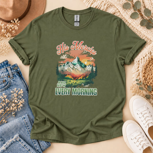 Olive t-shirt with "His Mercies Are New Every Morning" and mountain graphic.