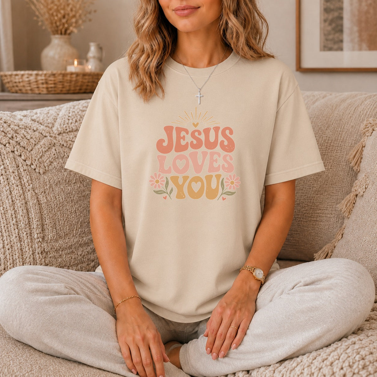 Beige t-shirt with "JESUS LOVES YOU" graphic in retro font.