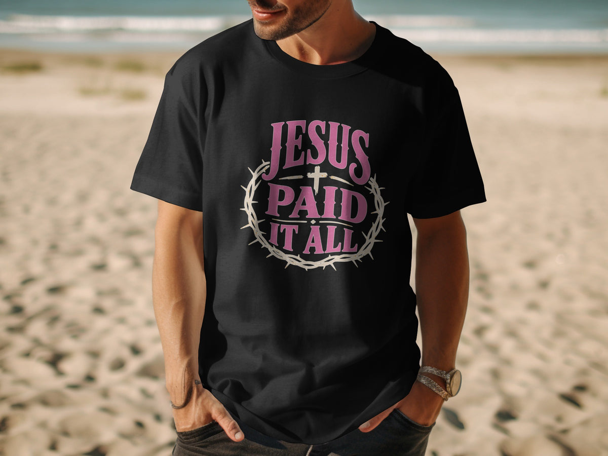 Black t-shirt with pink text "JESUS PAID IT ALL" and a crown of thorns.