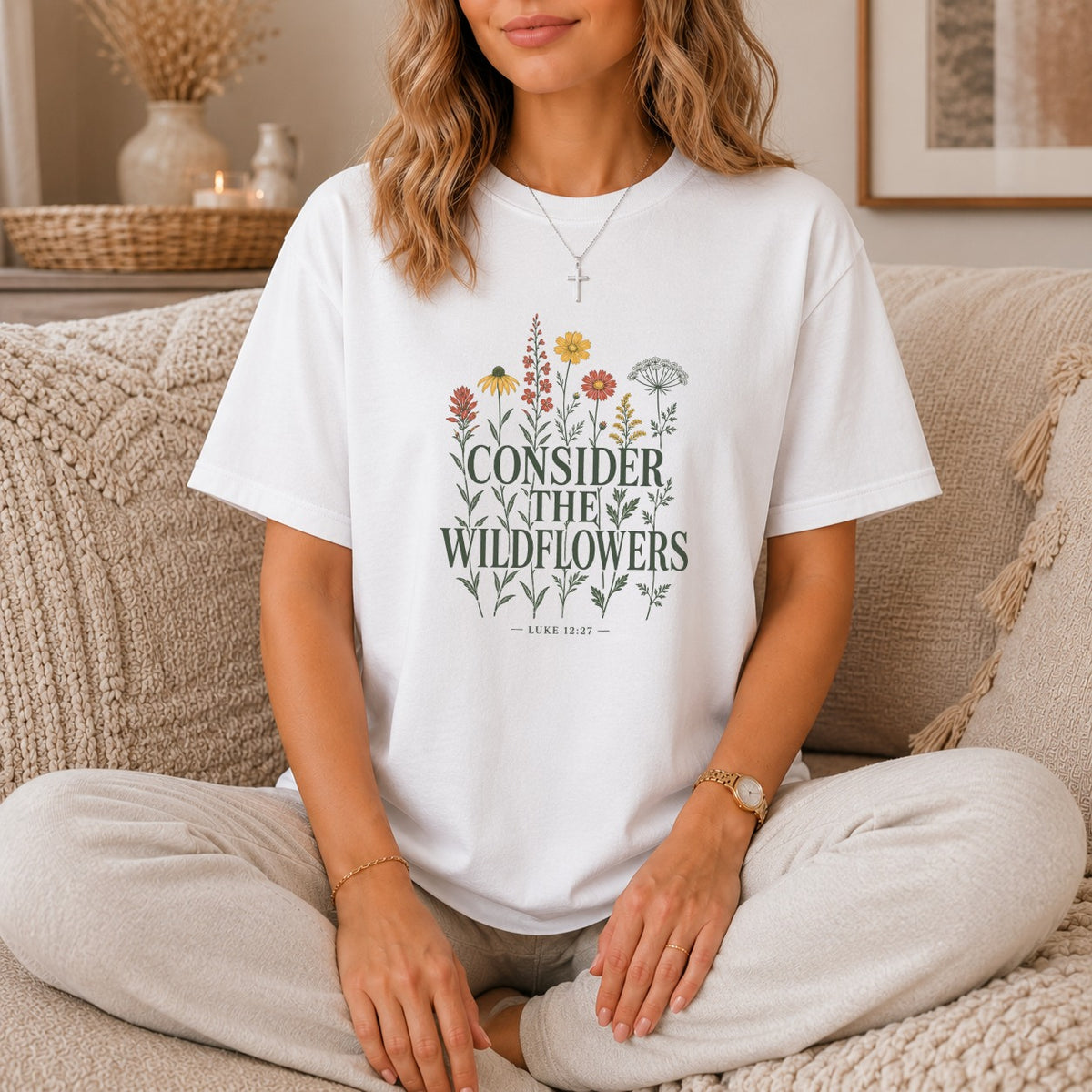 White t-shirt with floral graphic and text "CONSIDER THE WILDFLOWERS LUKE 12:27".