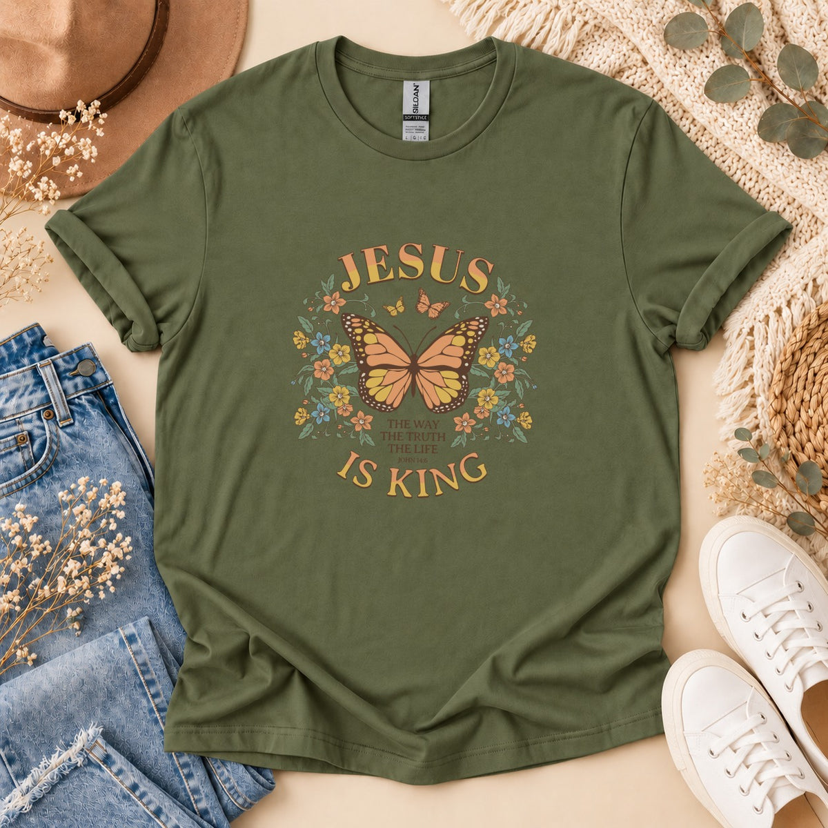 Olive green t-shirt with "JESUS IS KING" and butterfly floral design.