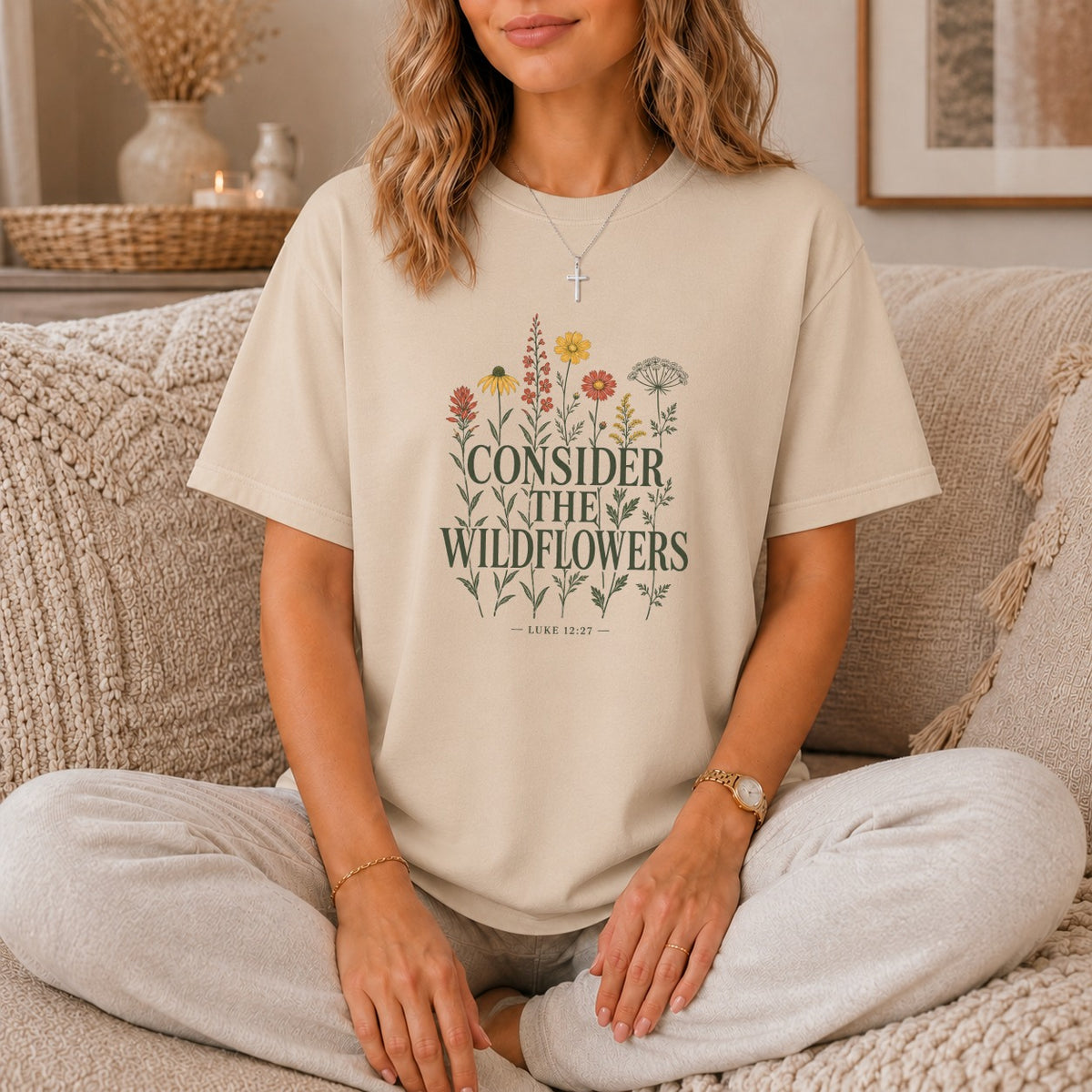 Beige t-shirt with "CONSIDER THE WILDFLOWERS" and "LUKE 12:27" text and floral design.