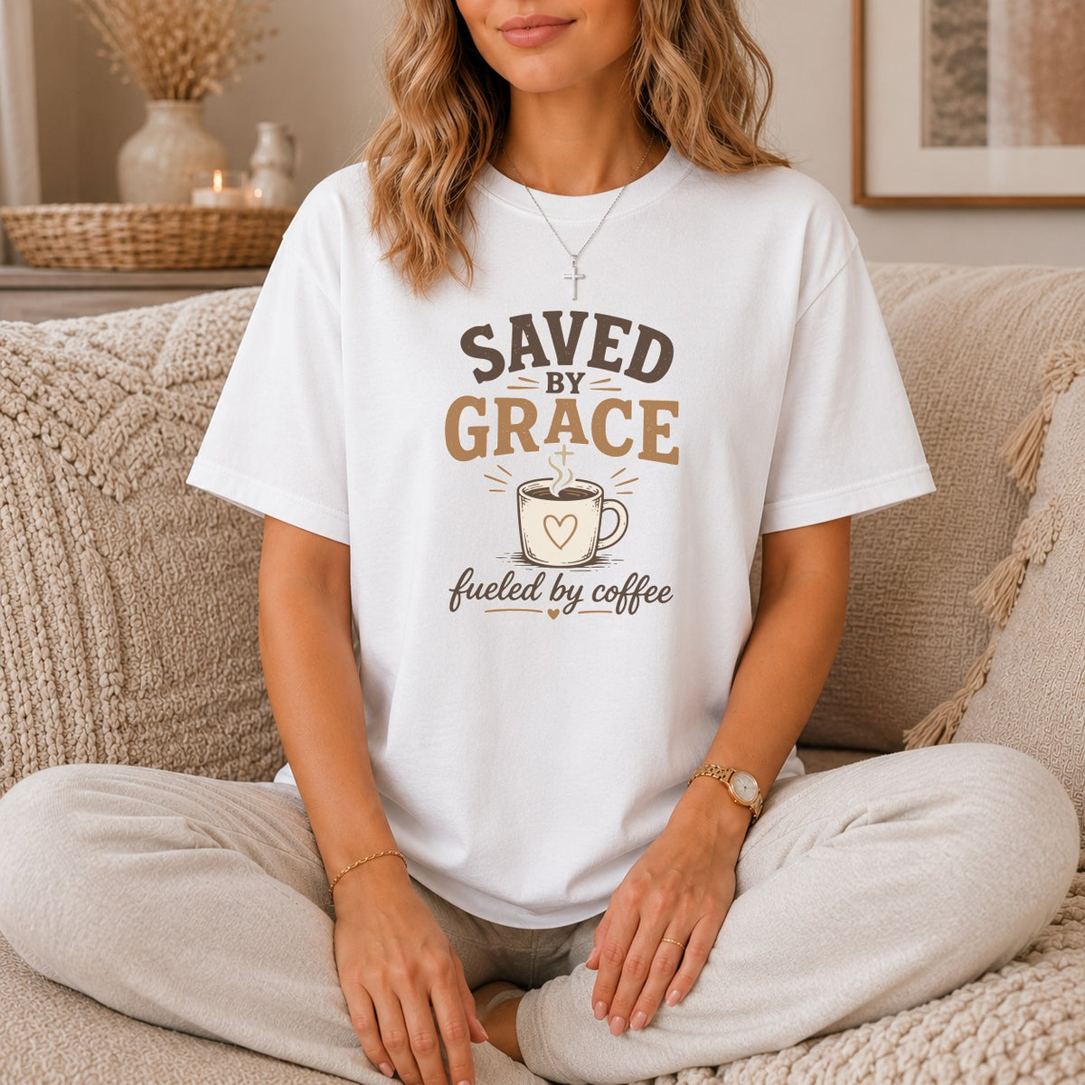 White t-shirt with text "Saved by Grace Fueled by Coffee" and coffee cup graphic.