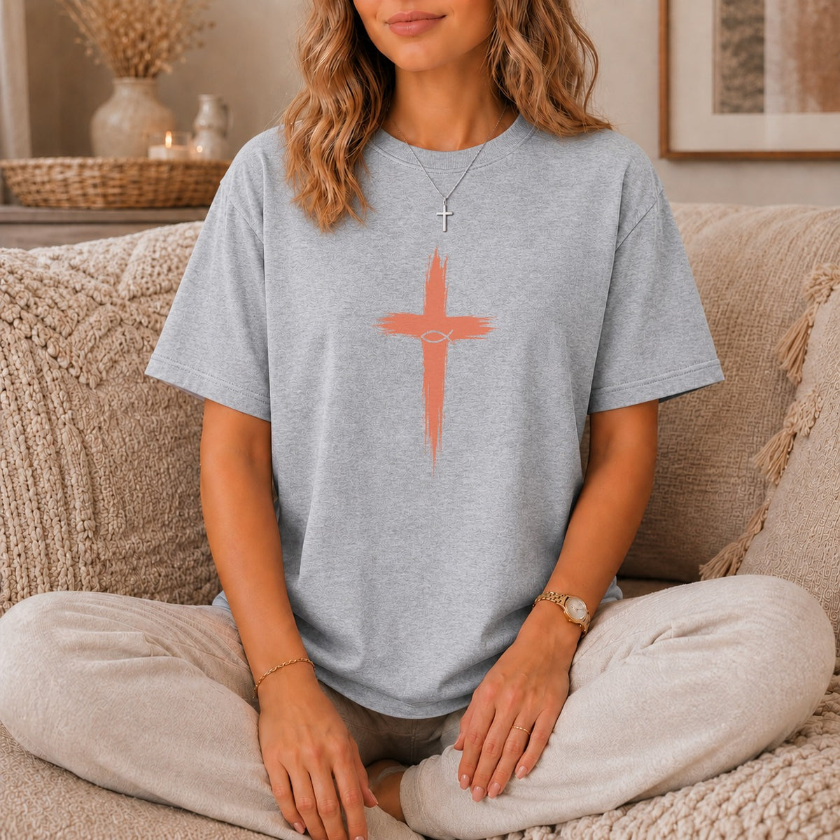 Grey t-shirt with coral painted cross and fish symbol design.