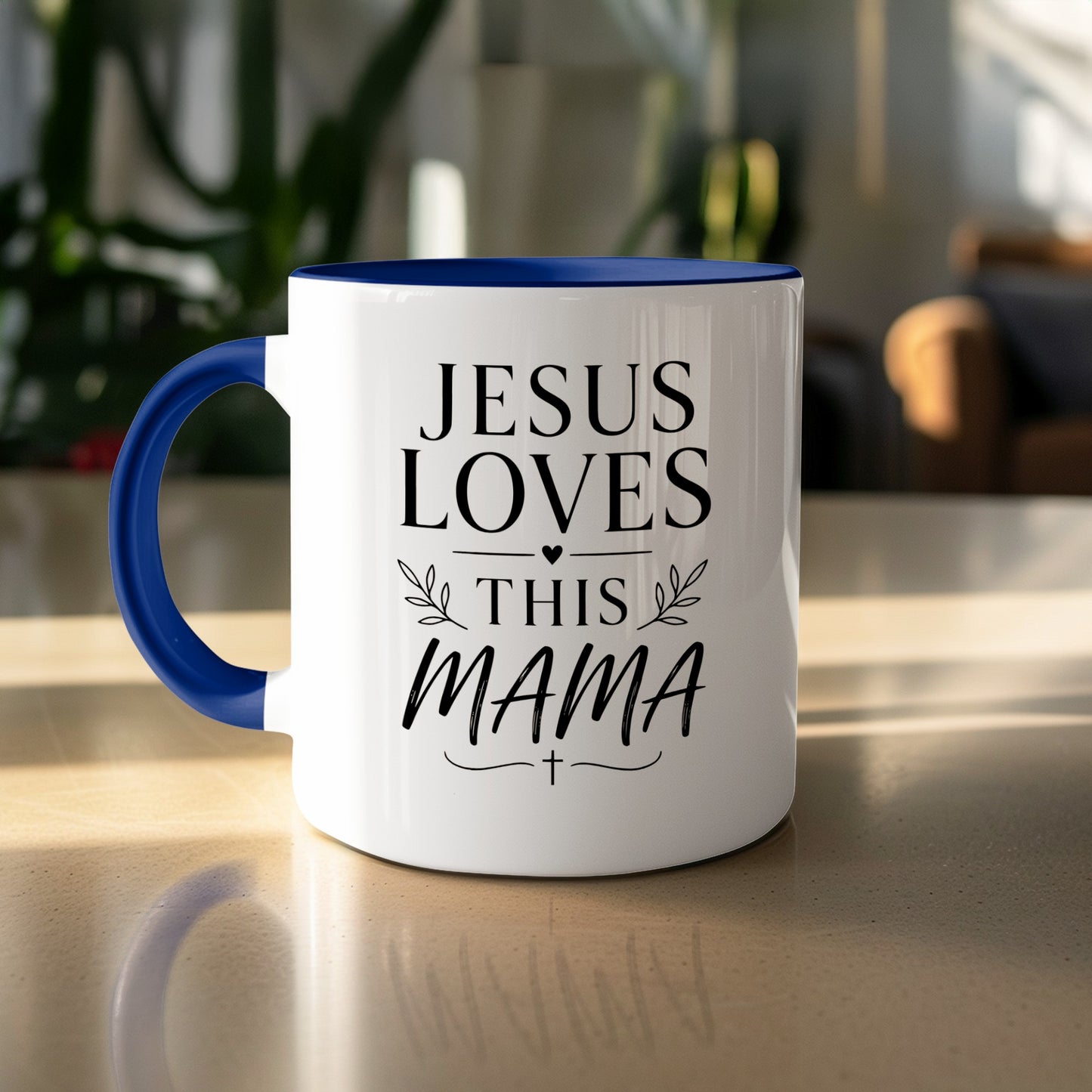 White mug with blue handle reading "JESUS LOVES THIS MAMA" and a cross.