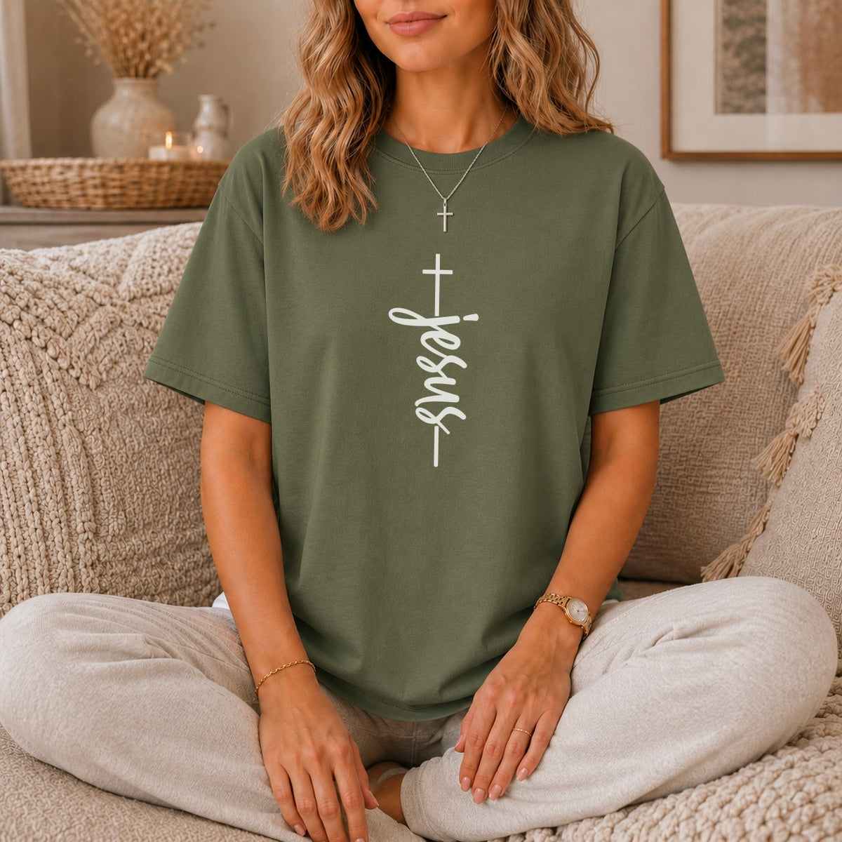 Green t-shirt with white vertical "Jesus" text and cross design.