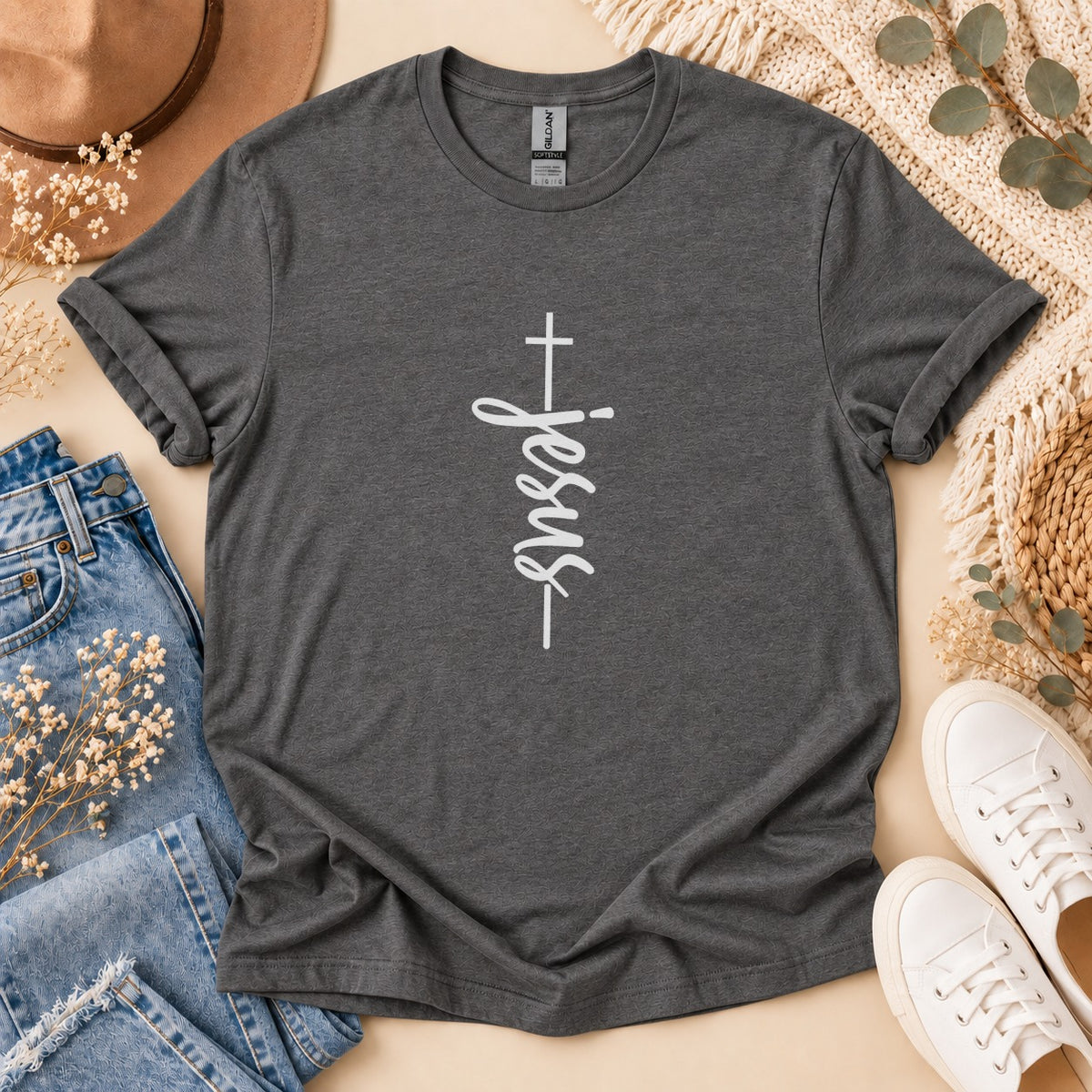 Dark gray t-shirt with white vertical "Jesus" text and cross graphic.