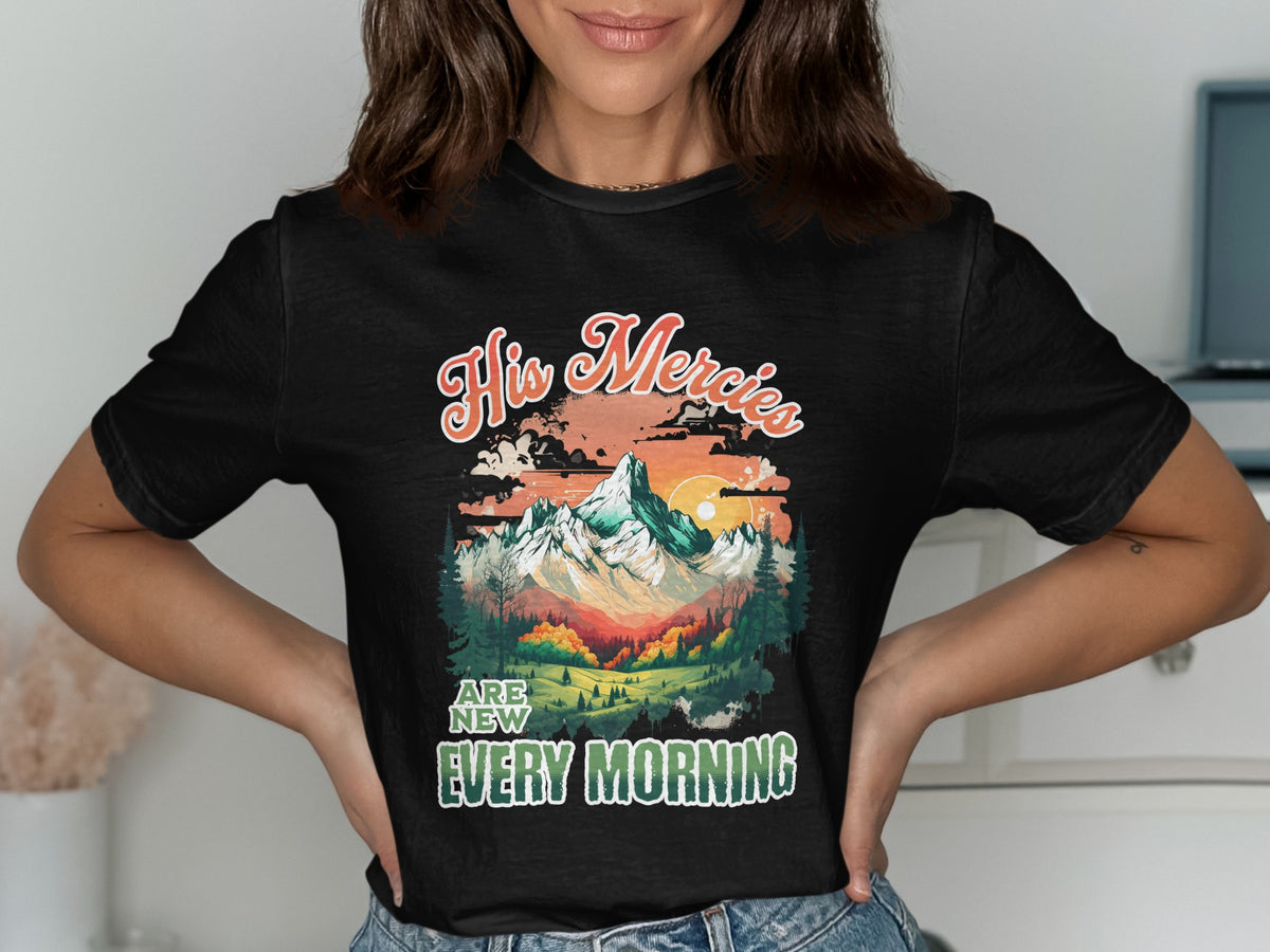 Black t-shirt with "His Mercies Are New Every Morning" text and mountain landscape graphic.