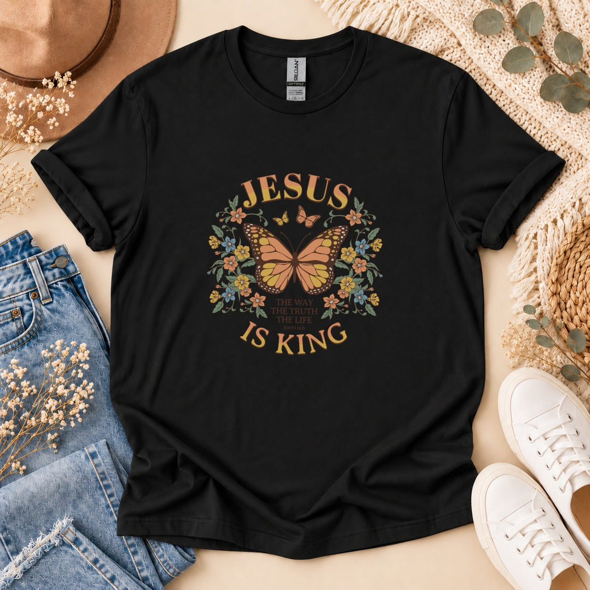 Black t-shirt with "Jesus Is King" text and butterfly floral graphic.