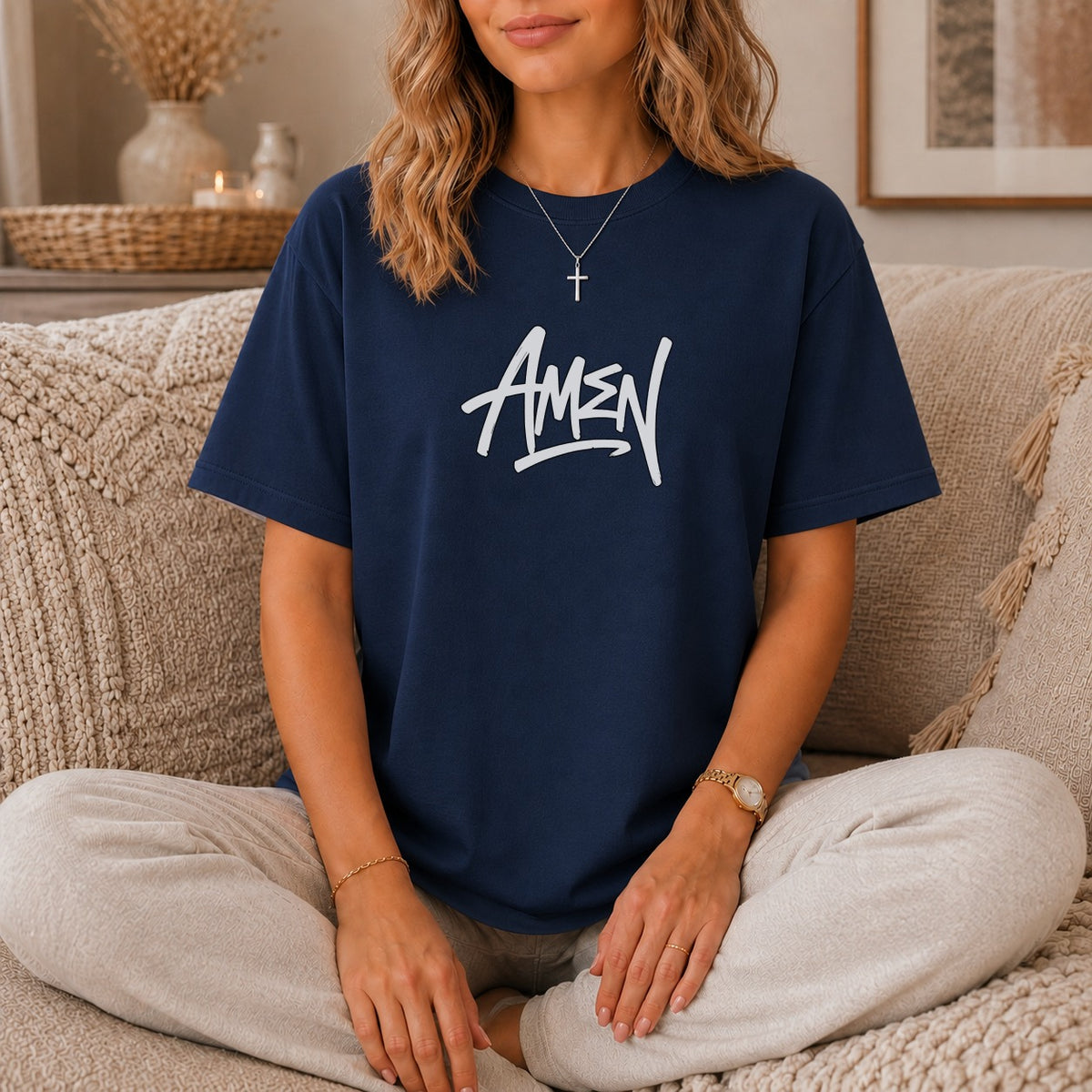 Navy t-shirt with white "AMEN" text and cross necklace on a woman.