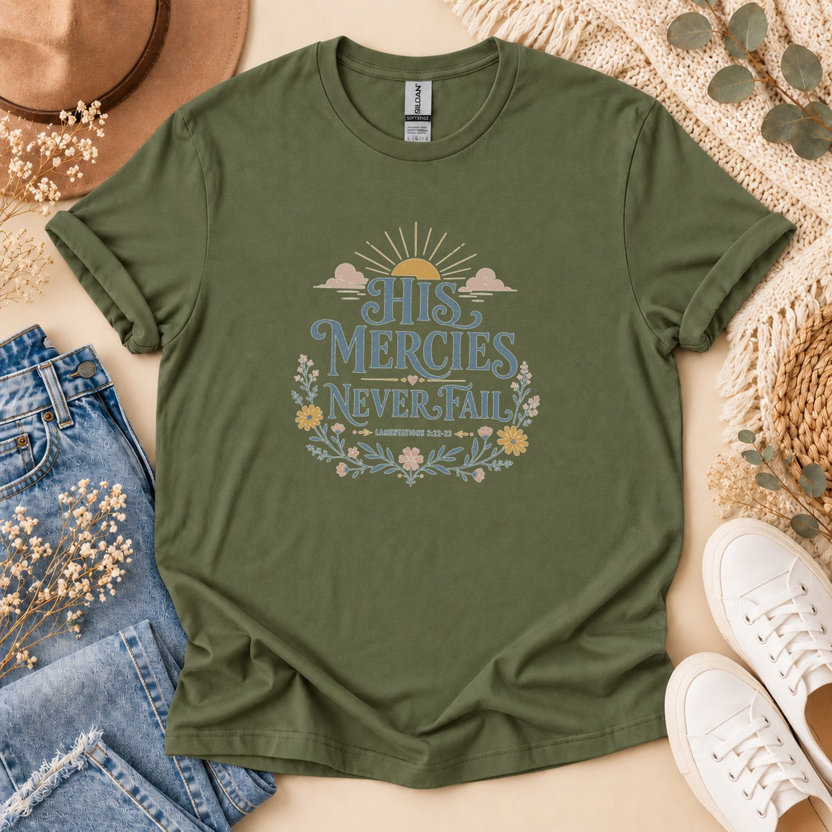 Olive green t-shirt with "His Mercies Never Fail" and "Lamentations 3:22-23" text.