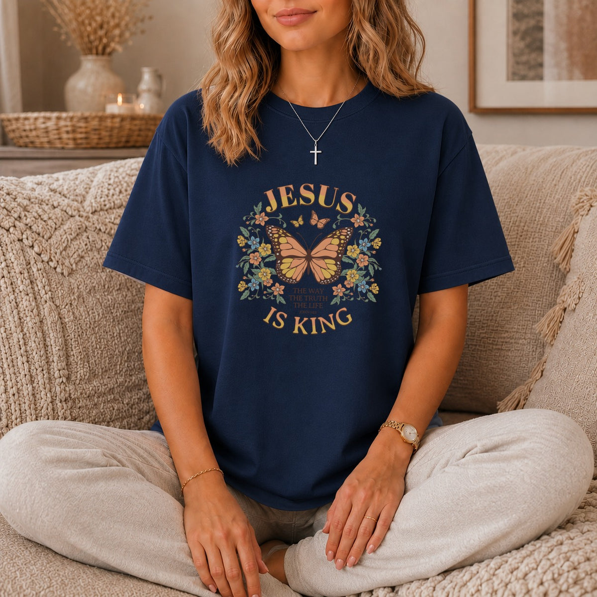 Navy t-shirt with "Jesus is King" text and butterfly graphic.