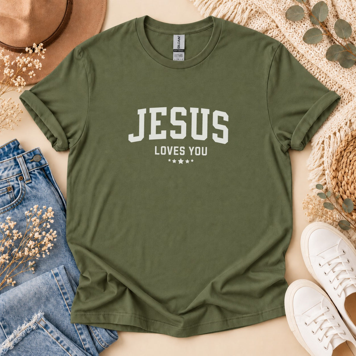 Olive green t-shirt with "JESUS LOVES YOU" in white block letters.