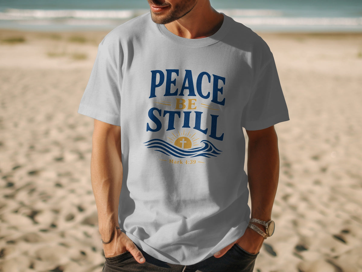 Gray t-shirt with "Peace Be Still" and a cross over waves, Mark 4:39.