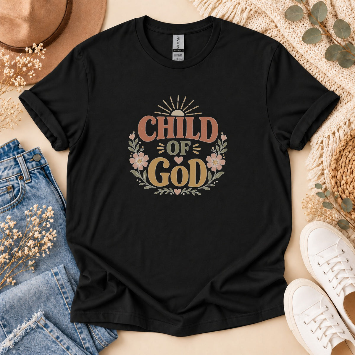 Black t-shirt with "CHILD OF GOD" in a circular floral design with sunburst.