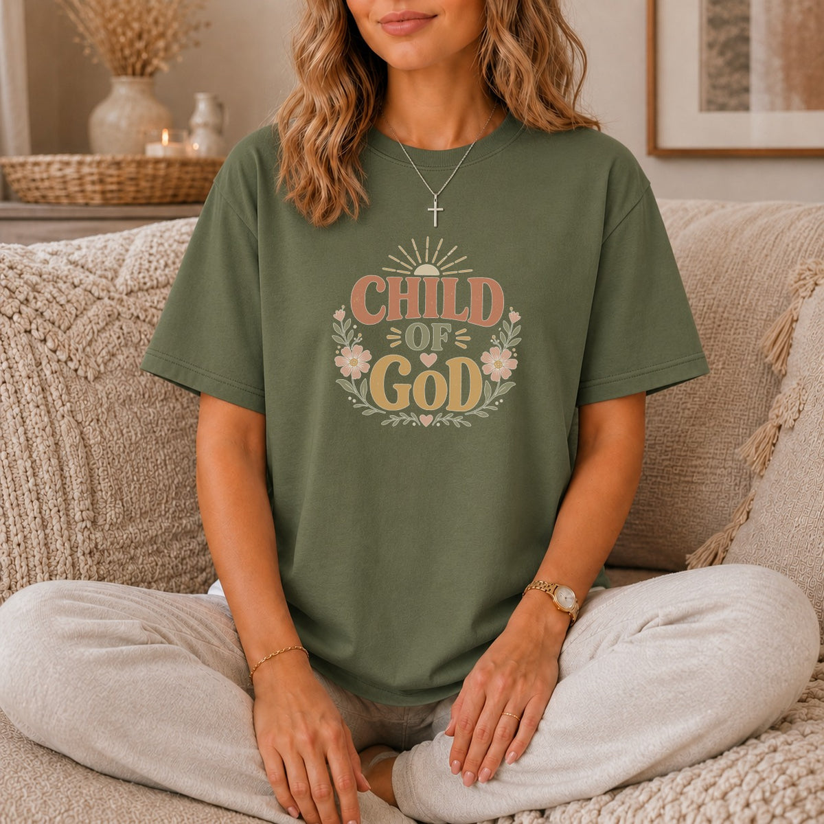 Olive green t-shirt with "CHILD OF GOD" text and floral wreath design.
