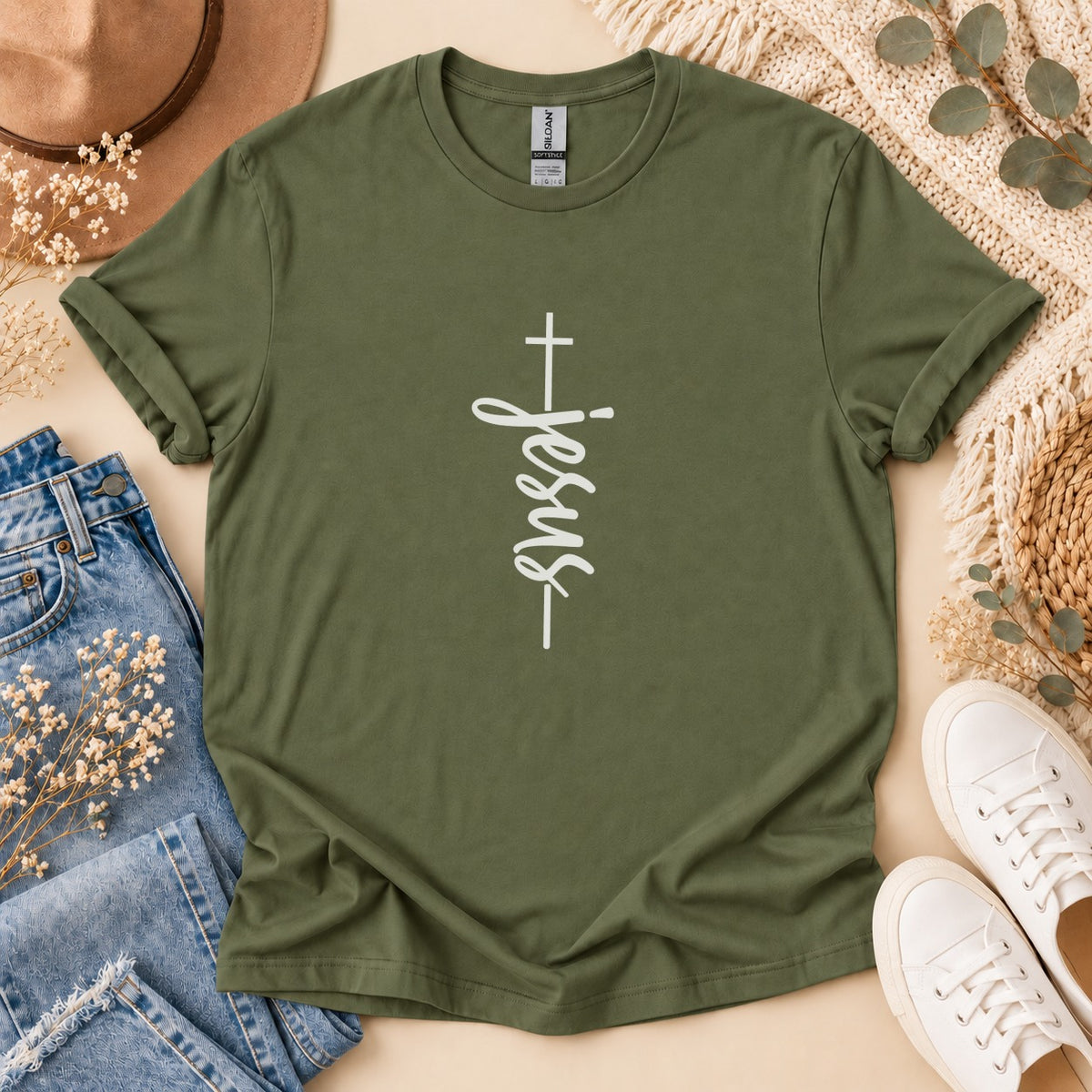 Olive green t-shirt with white vertical "Jesus" text and cross design.